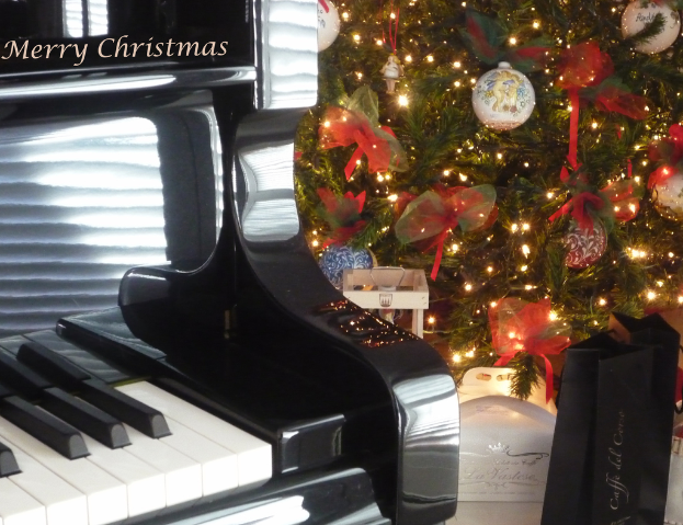 Ein Weihnachtsbaum und ein Piano auf dem Boden mit verschiedenen GegenstÃ¤nden auf dem Baum.