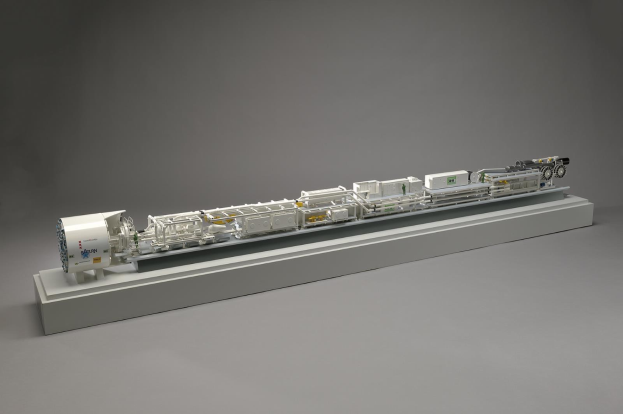 Ein detailliertes Modell eines großen Wasserstoff-Brennstoffzellensystems, das miteinander verbundene Komponenten wie einen Kraftstofftank, ein Filter und eine Einspritzdüse auf einer weißen Oberfläche zeigt.